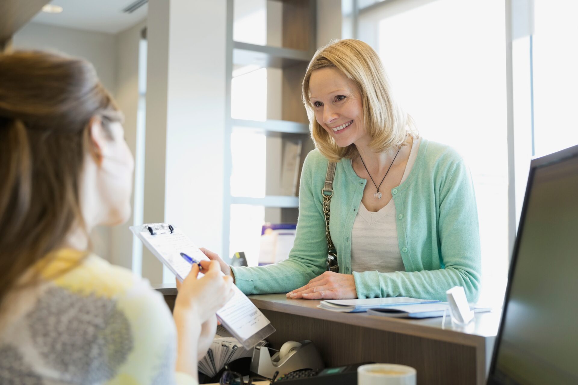Receptionist explaining interest free payment implants for dental